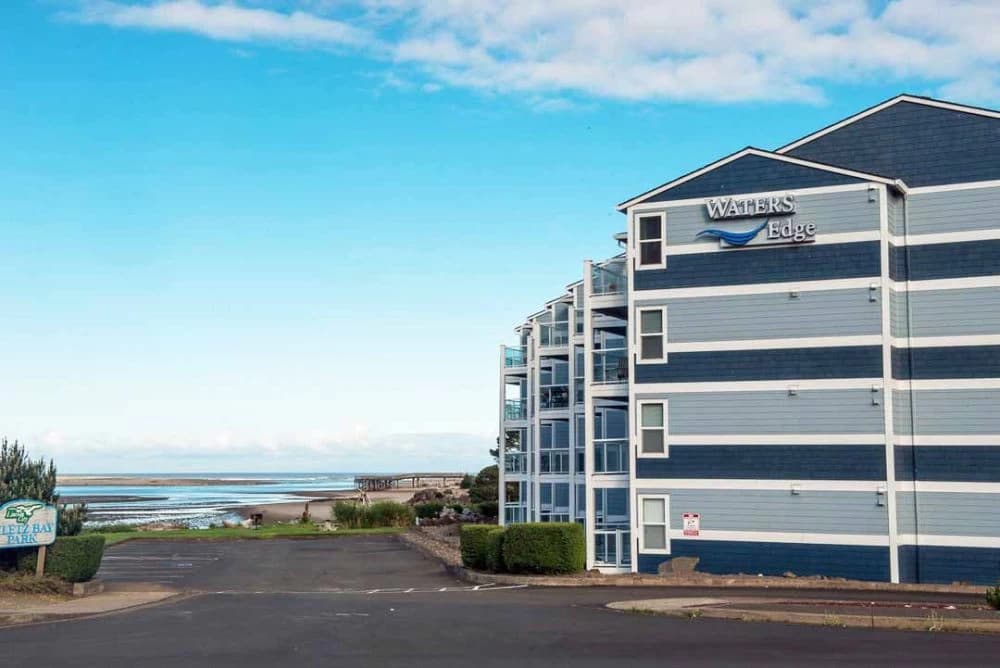 Blue-and-navy striped condo in Lincoln City with glass balconies beside the bay