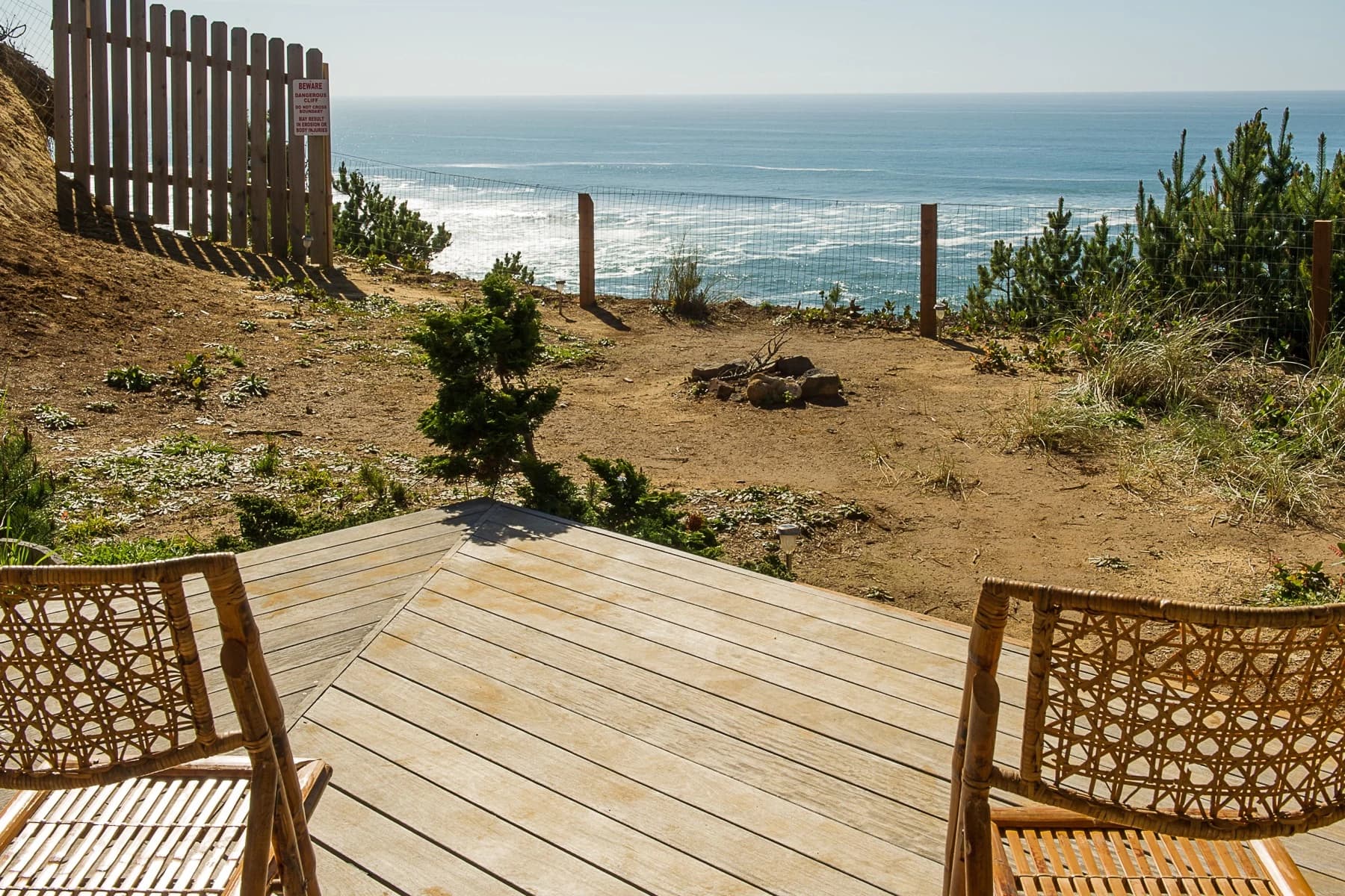 Wooden deck and stone fire pit overlooking the ocean in Gleneden Beach