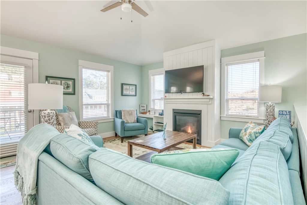 Light blue sectional and white fireplace in a mint-walled living room in Lincoln City