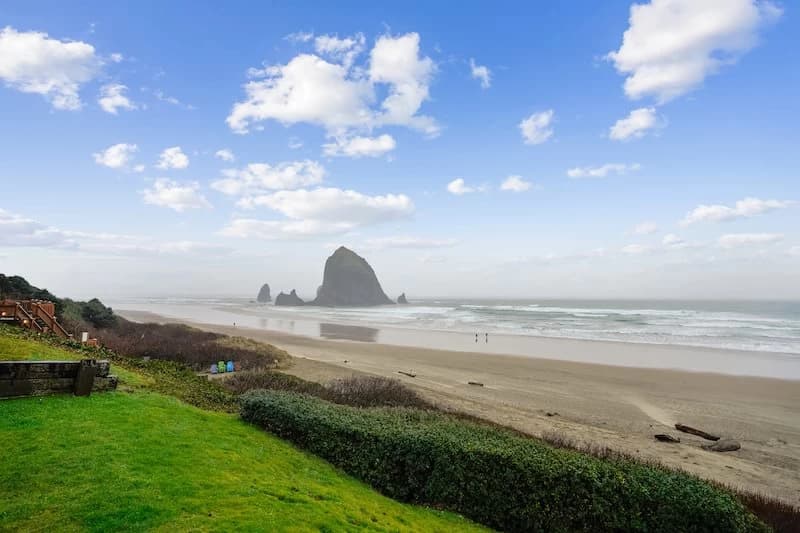 Grassy lawn in Cannon Beach looking over the beach toward Haystack Rock and ocean