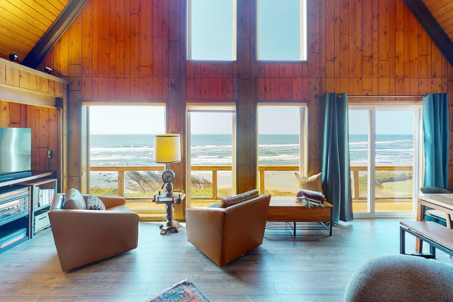 Wood-paneled Florence living room with leather chairs facing the ocean deck