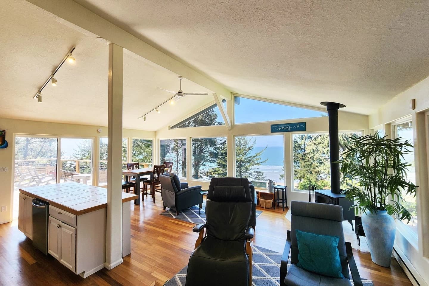 Otter Rock living room with a wood stove, dining table, and ocean-view windows