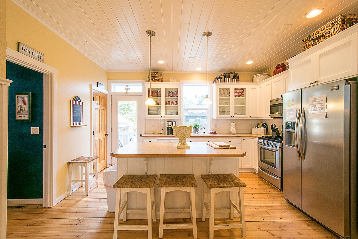 Luxury four-level cedar shake beach house with white trim and 3 decks.